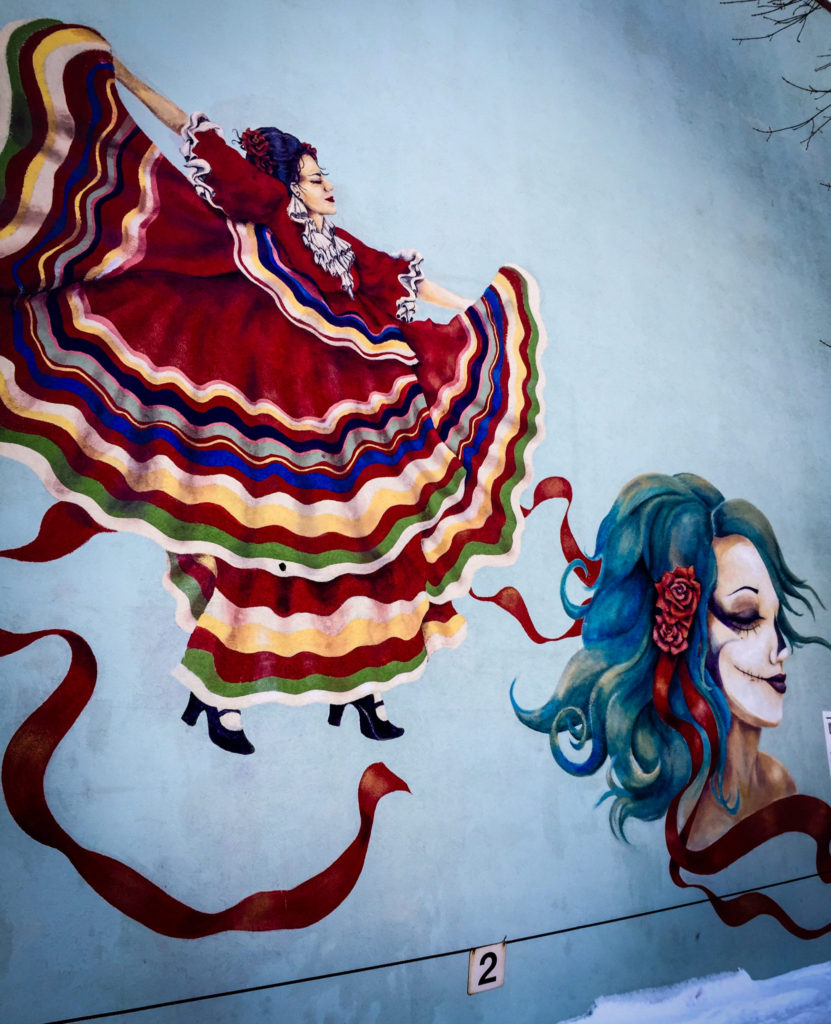 Mexican dancer and death mask mural