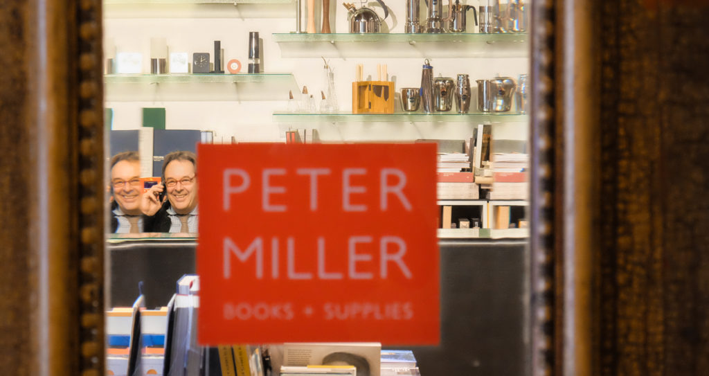 Peter Miller through the shop's door.